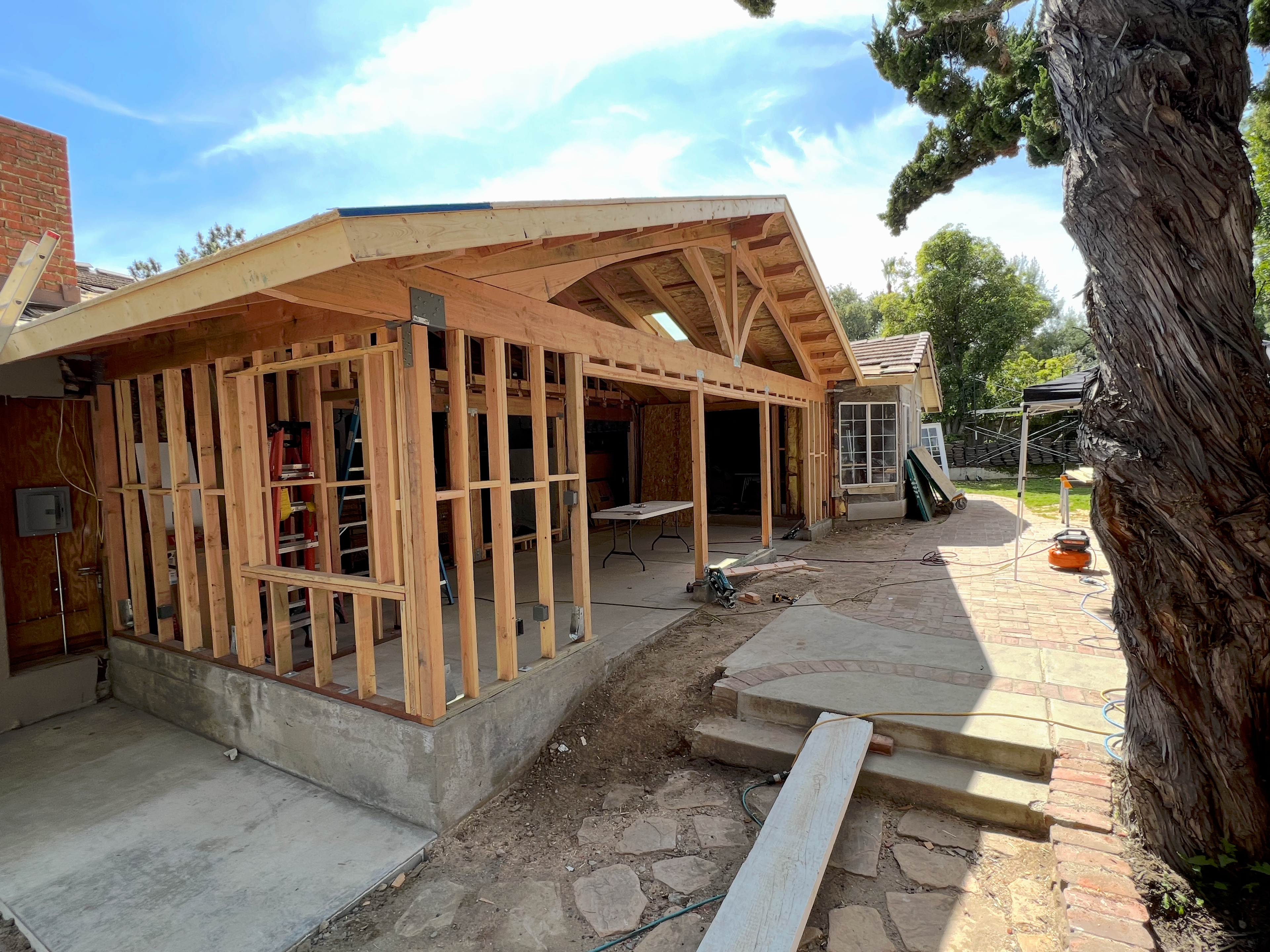 Residential home addition framing with exposed wooden beams and structure