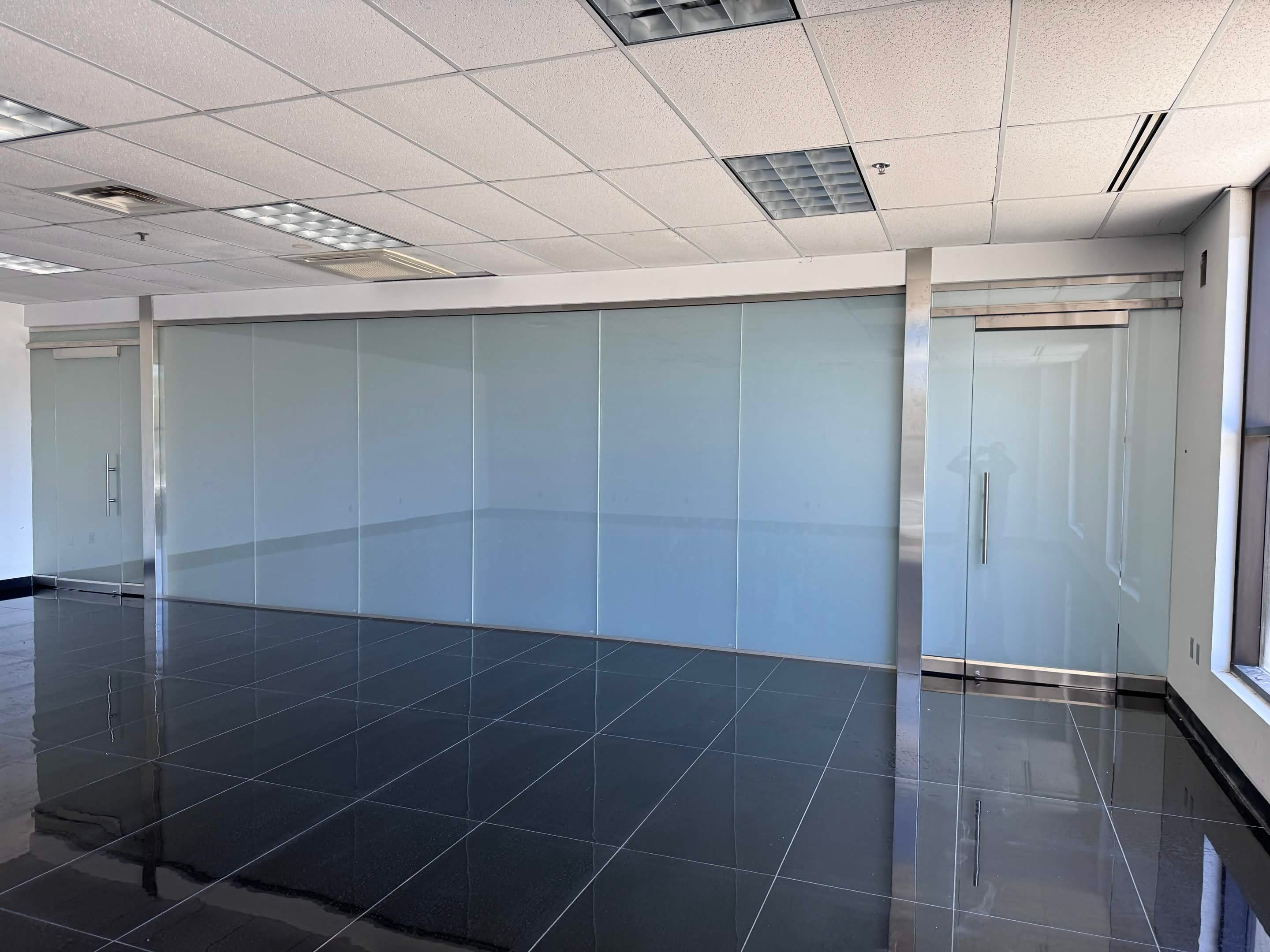 Commercial glazing — glass partition installation in an office space